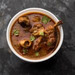 Mutton Masala Curry in plastic container for home delivery